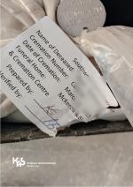 kartka i metalowy znaczek potwierdzające kremację